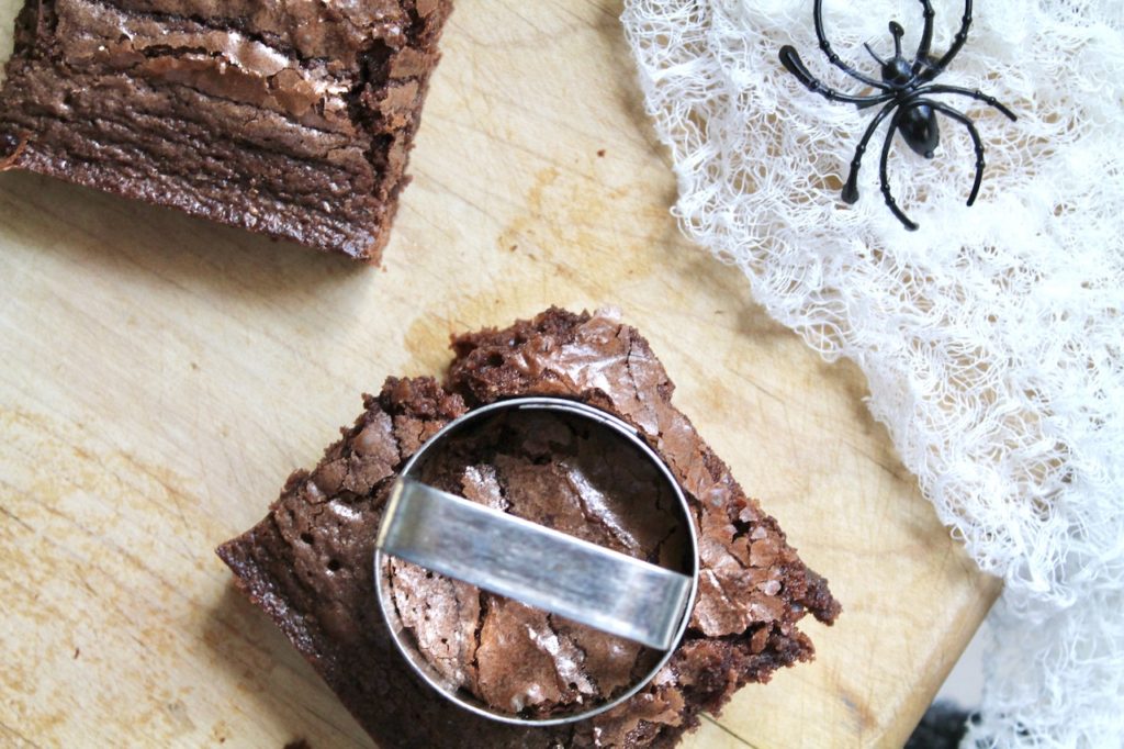 use round cutter to cut out spooky spider bite brownies