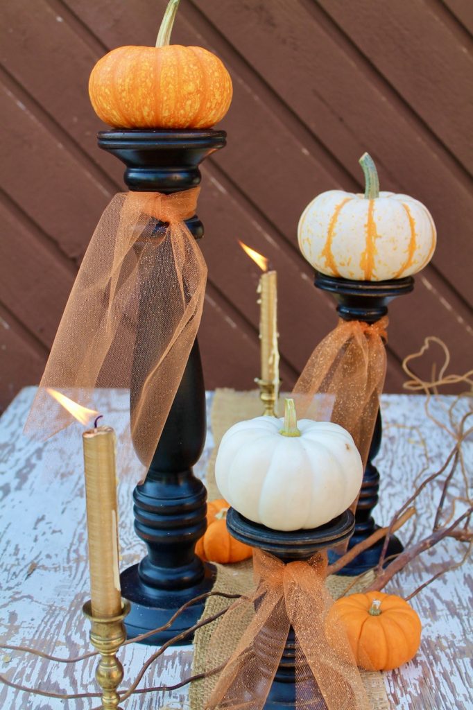 pumpkins on pillar candle holders