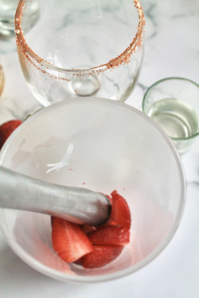 muddle strawberries for your strawberry mango margarita