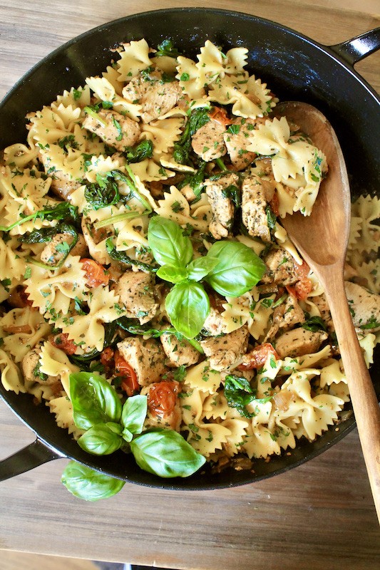 garnish chicken and bow tie pasta recipe with fresh parsley and basil