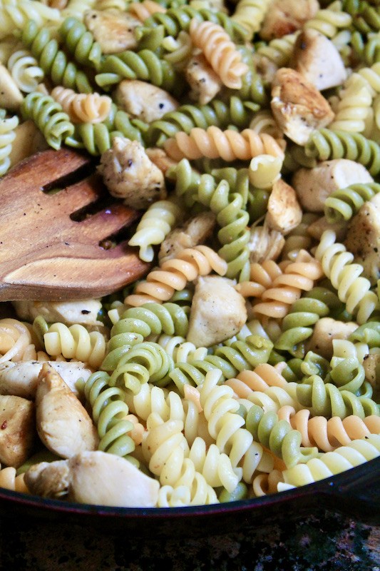 add cooked pasta to skillet with chicken