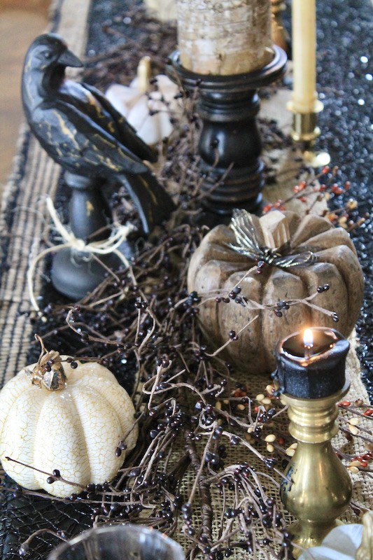 pumpkins and taper candles for spooky black raven halloween table decor