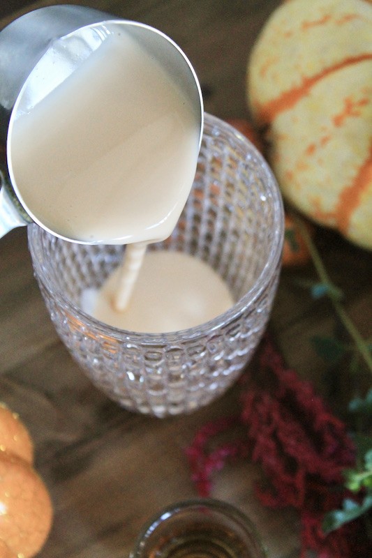 pour some pumpkin spice egg nog in a cocktail shaker