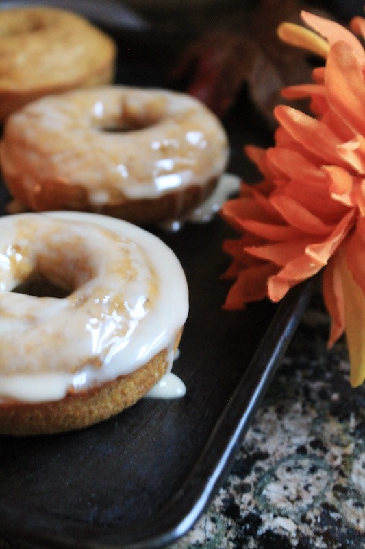 glaze baked pumpkin maple donuts by making a glaze with powdered sugar, brandy, and maple syrup