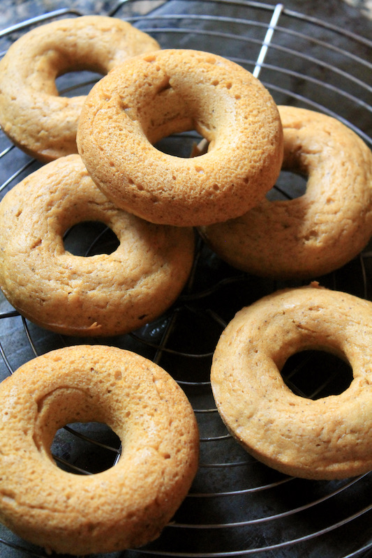 cool baked pumpkin maple donuts on a rack