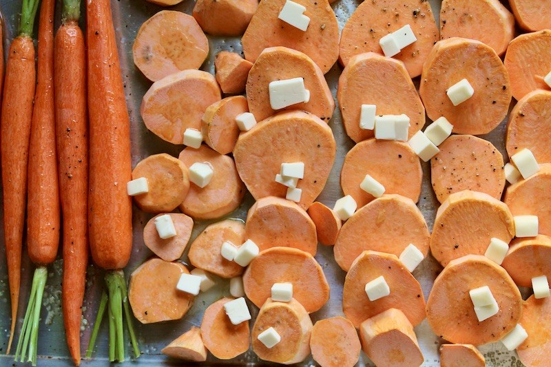 roast carrots and sweet potatoes on a sheet pan