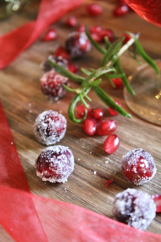 make a festive garnish by rolling cranberries in simple syrup and sugar then putting on skewer for a garnish