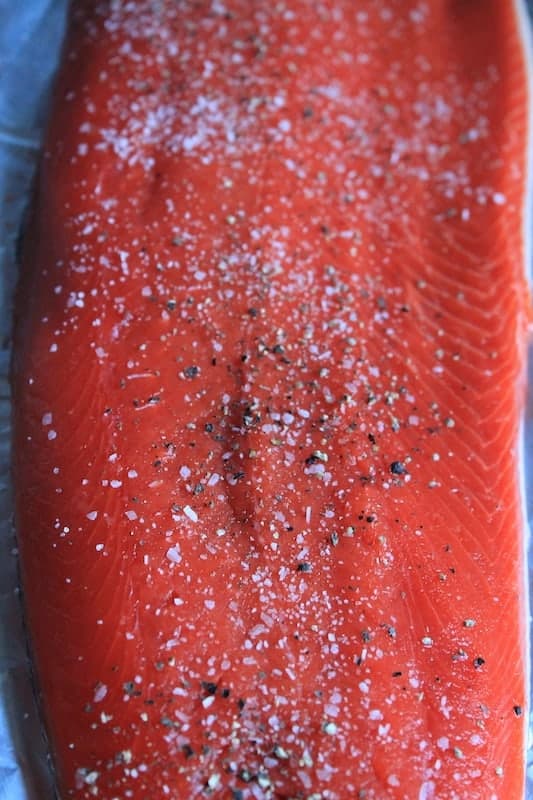 season your wild caught sockeye salmon fillet with salt and pepper
