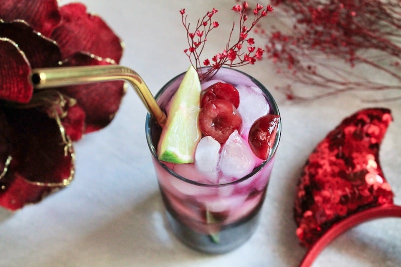 garnish tequila fizz cocktail with cherry and lime