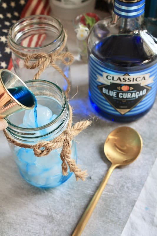 add blue curacao to your fourth of july spritzer cocktail