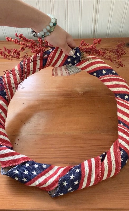 tuck in the edges of the ribbon and make a snug clean look with the ribobn on the wreath