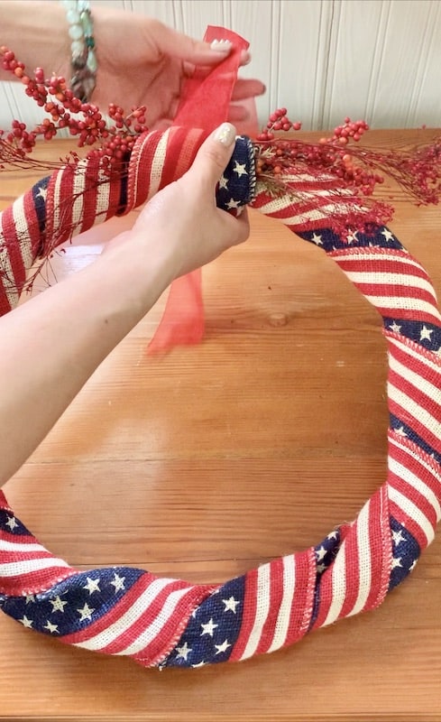 add sheer ribbon to your DIY 4th of July Patriotic Wreath to hang it from your door