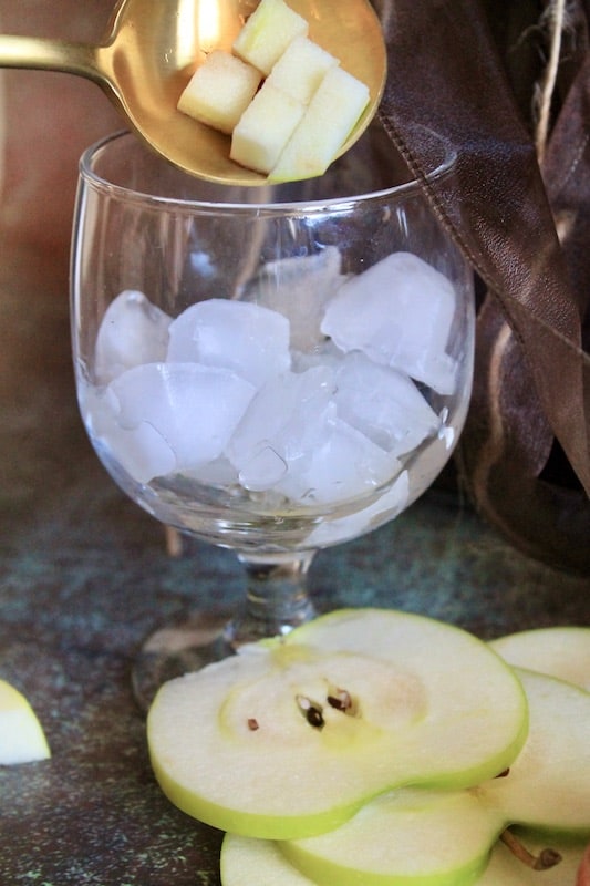 top off your glass with ice and cubed green apples
