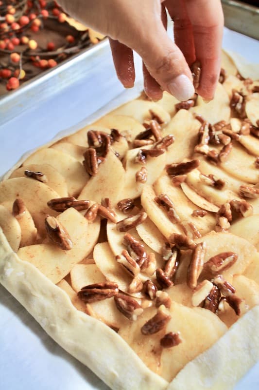 sprinkle pecans over apples in the tart
