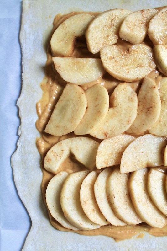 place sliced apples on the puff pastry sheet over the pumpkin mixture