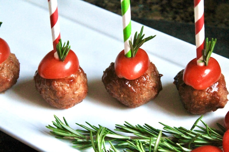 garnish meatballs with tomato, rosemary, and skewers