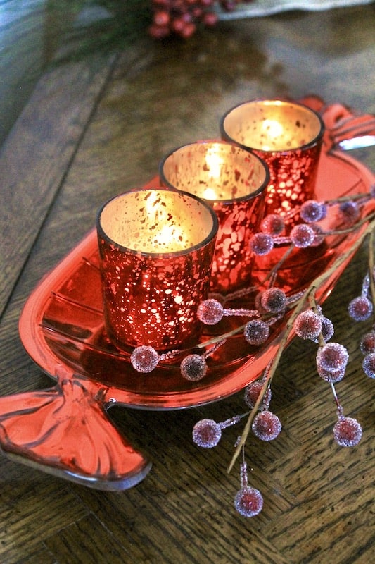 red candy dish with votives christmas table centerpiece