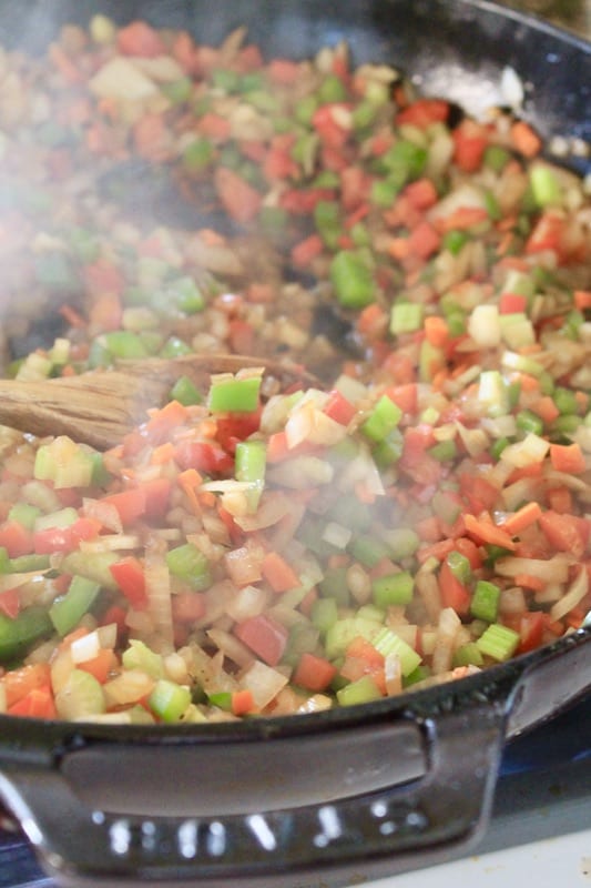 add tomato and garlic to skillet for jambalaya rice vegetables