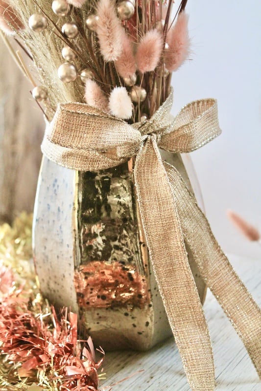gold burlap ribbon and gold vase with pink and gold new years eve flowers centerpiece