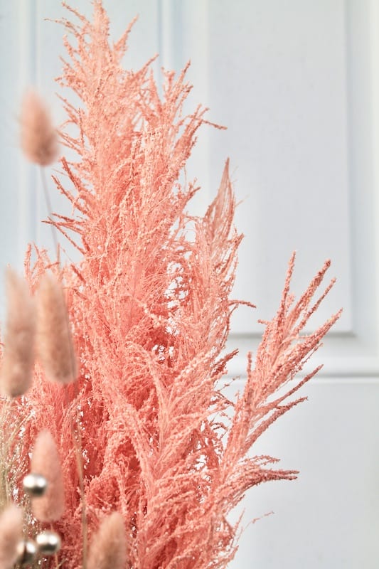 pink coral pink pampas grass stems in a floral new years eve centerpiece