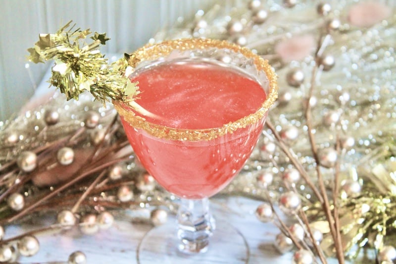 dip cocktail glass in syrup then in gold sanding sugar put in freezer