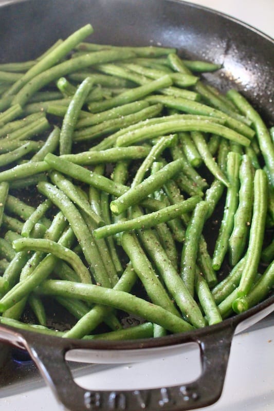 continue cooking green beans with lemon garlic and white wine