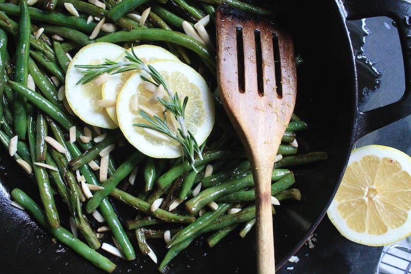 add green beans to a wide skillet and toss around until the skins brown from the heat then season with salt and pepper