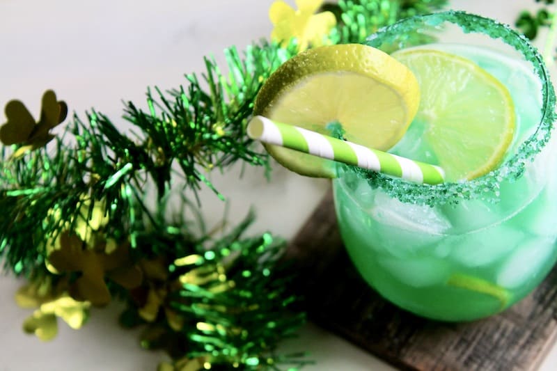 pour into a margarita glass dipped in sea salt and green sanding sugar