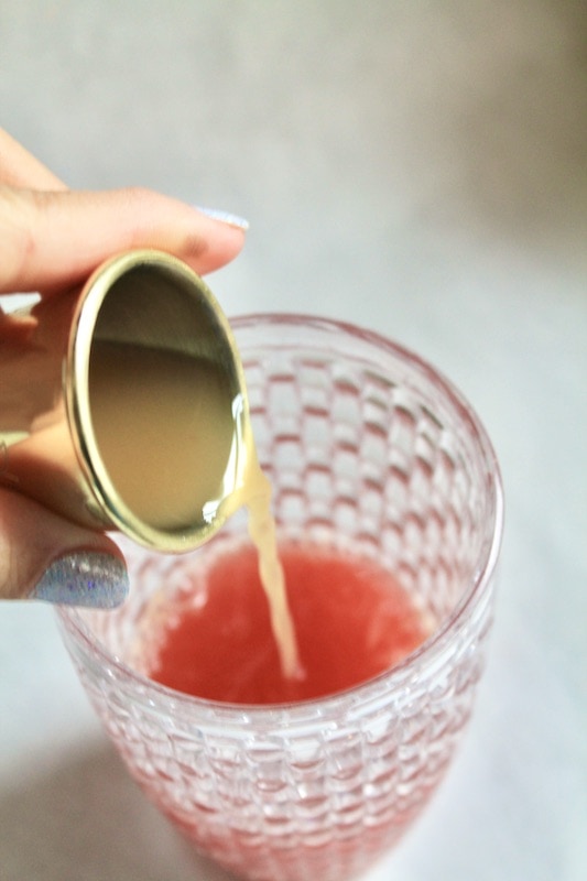 combine blood orange juice apple cider grand marnier lemon juice and simple syrup and cinnamon plus nutmeg in a cocktail shaker and shake until chilled