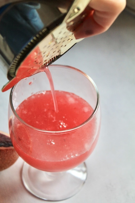 add lemon and vodka to the cocktail shaker and splash in a little vanilla syrup.