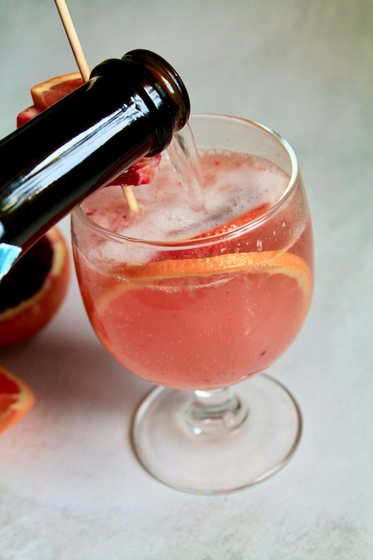 strain and top off blood orange cocktail with chilled prosecco or champagne