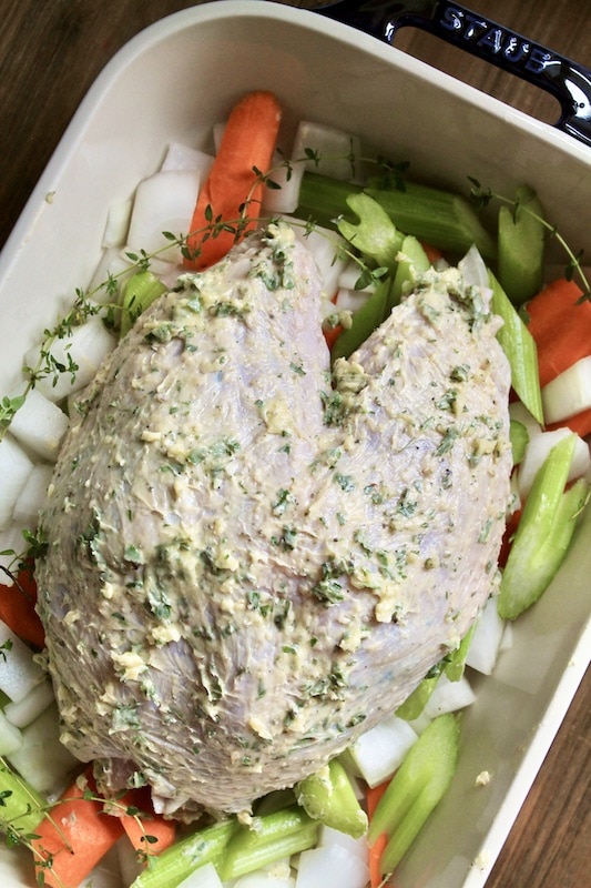 place turkey breast over vegetables in pan