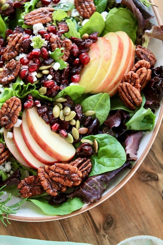 sprinkle the thanksgiving salad with dried cranberries, and pumpkin seeds