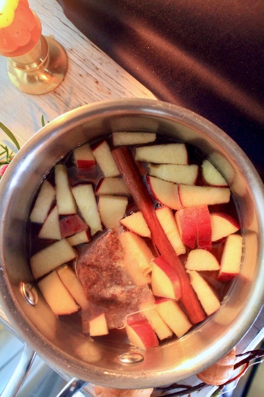 steep apples cinnamon pumpkin wine apple cider and mulling spices packet in sauce pan