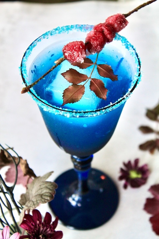 add light rum lemon juice simple syrup apple cranberry juice and blue curacao to cocktail shaker with ice