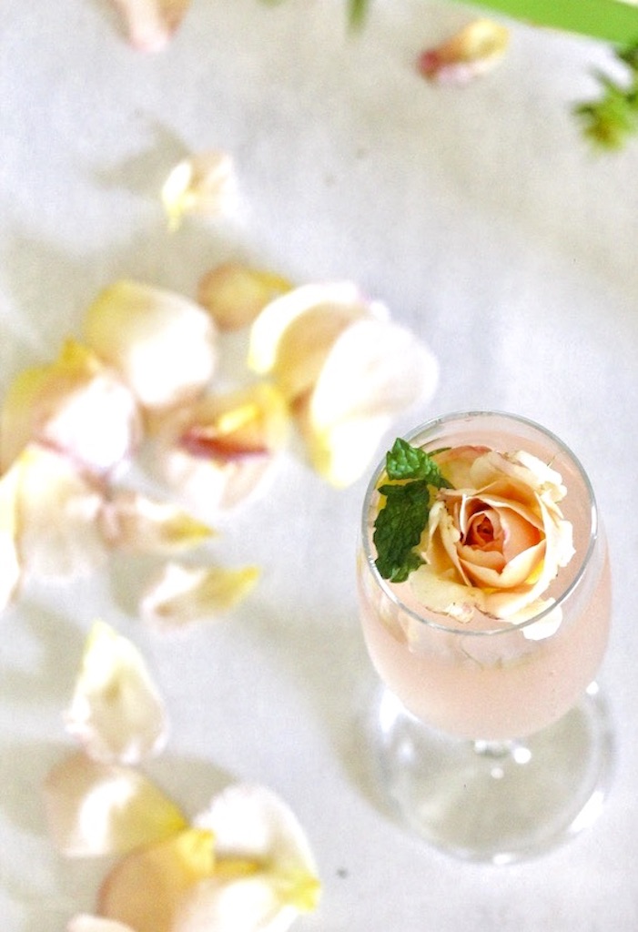 strain top with sparkling water and garnish with rose petals and mint