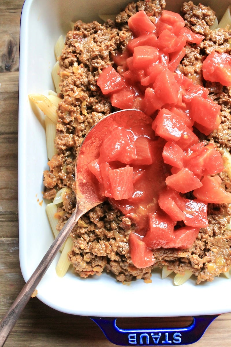 add a can of diced tomatoes and juices to the taco meat