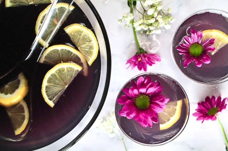 combine gin blue curacao simple syrup and strawberry lemonade in a punch bowl.
