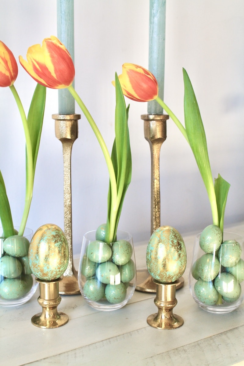 red and orange tulips add color to this quiet, muted diy easter decor with candles