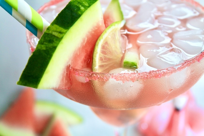 a festive watermelon tequila summer cocktail is made on the rocks with 4 ingredients