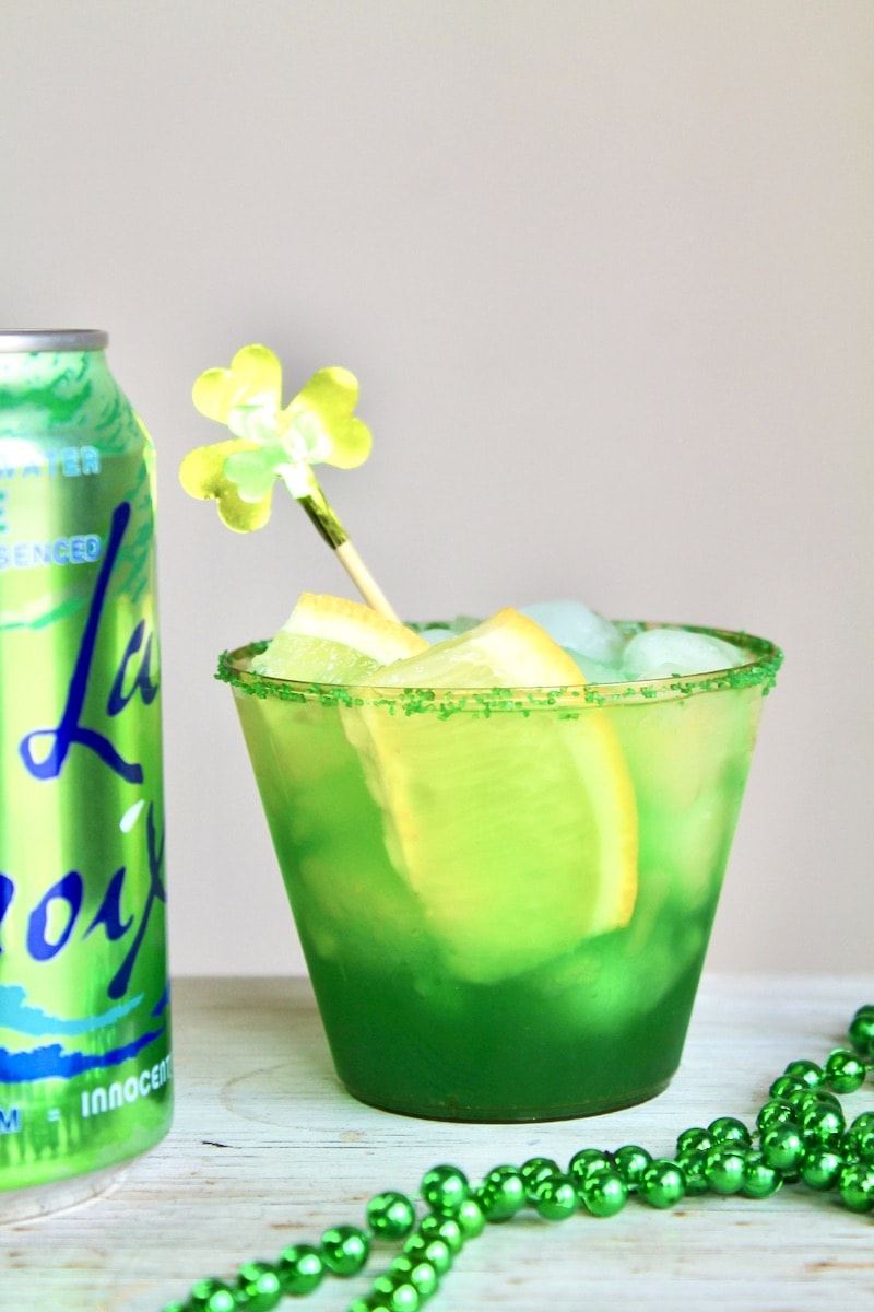 pour into a cocktail glass and top off with fresh lemon slices and sparkling lime water