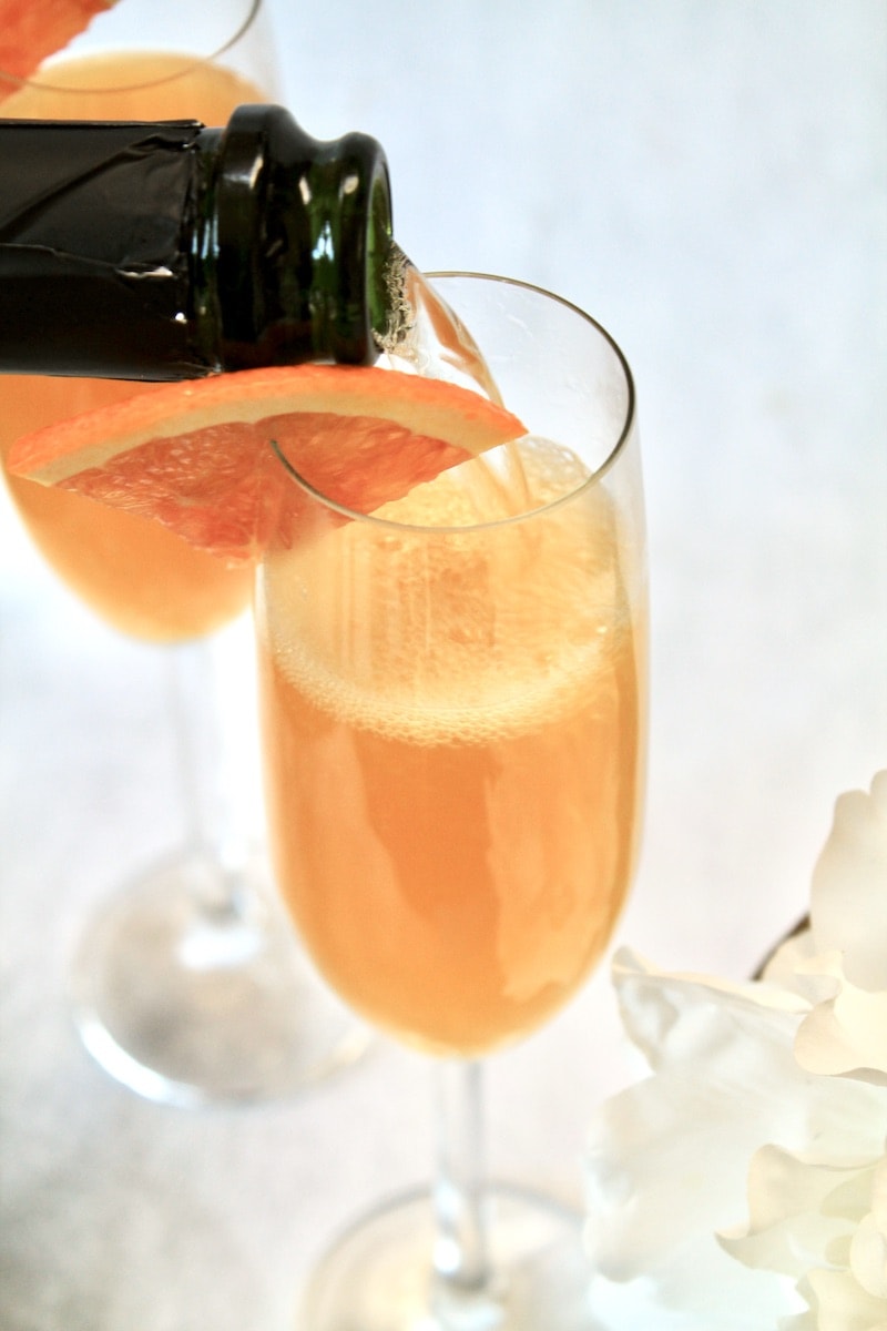 combine orange juice and mango juices in a champagne flute and top off with 2 ounces or so of chilled champagne or prosecco