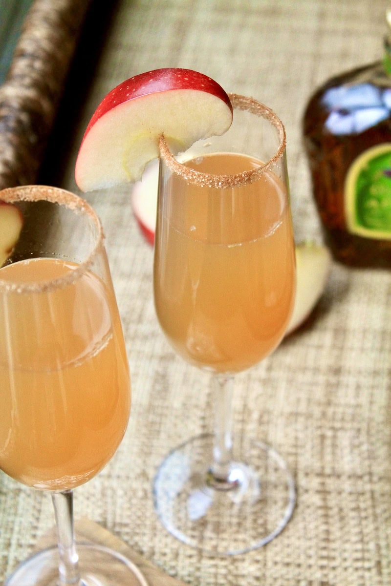 in a cocktail shaker with ice combine apple whiskey maple syrup lemon juice and apple cider shake and strain into champagne flutes