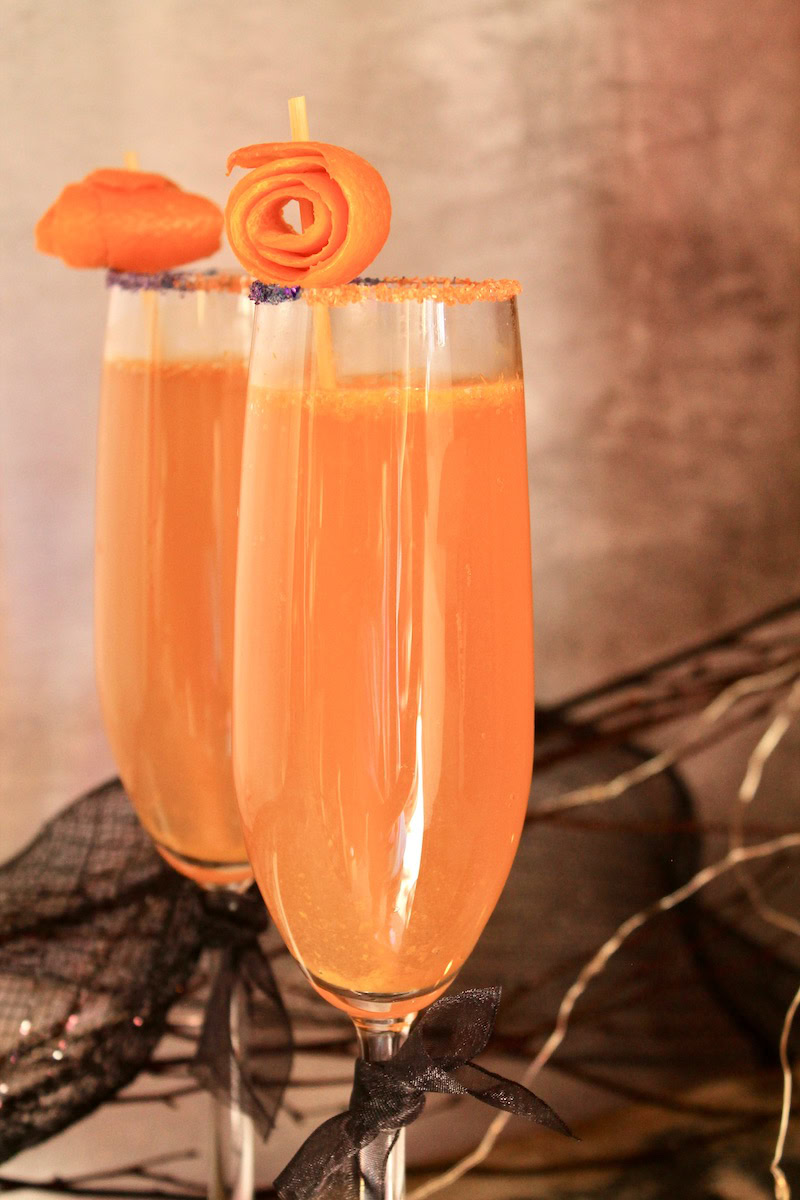 festive orange halloween mimosa cocktails