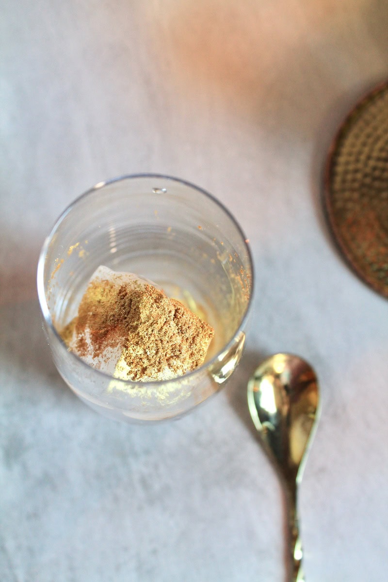 pour edible gold dust in the glass with ice
