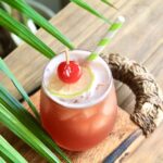 summer rum drink with pineapple juice and cranberry