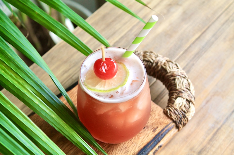 summer rum drink with pineapple juice and cranberry