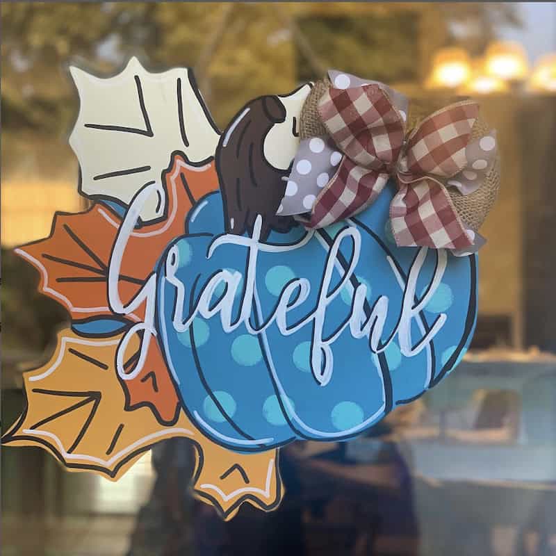 diy fall door decoration with blue pumpkin and leaves
