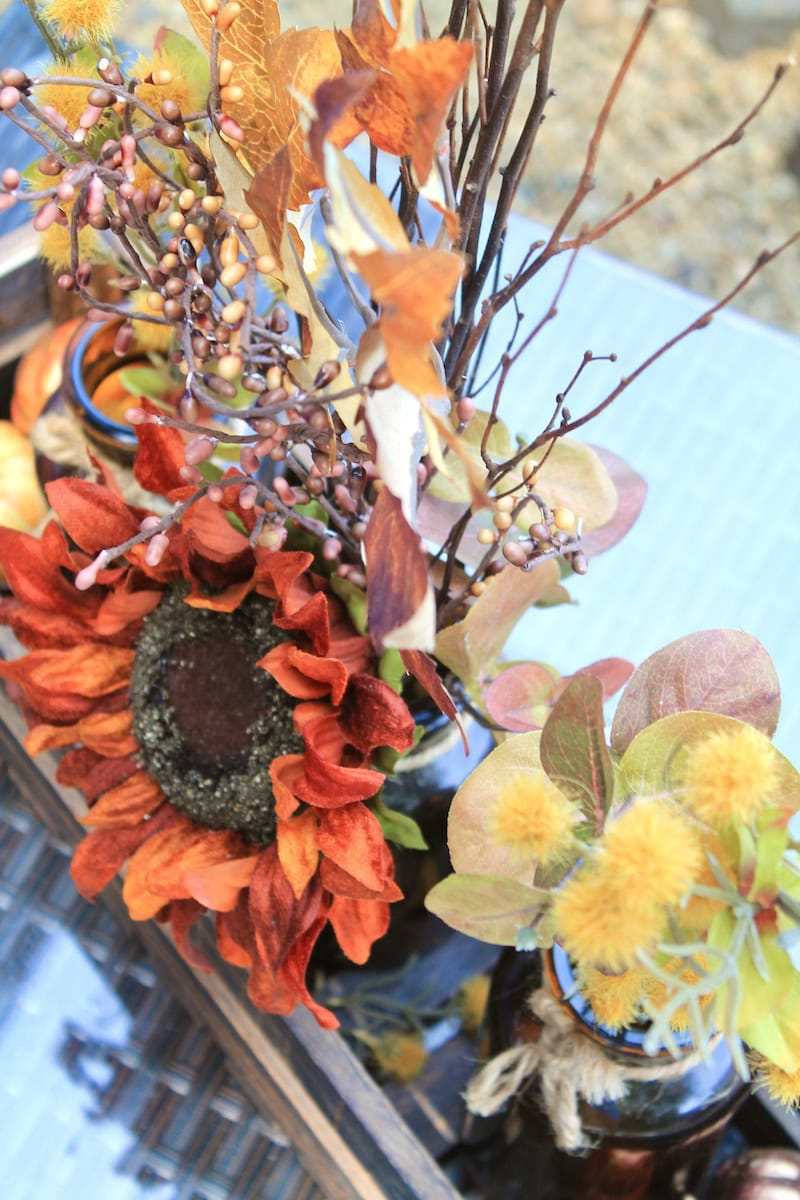 festive fall centerpiece with branches and sunflowers